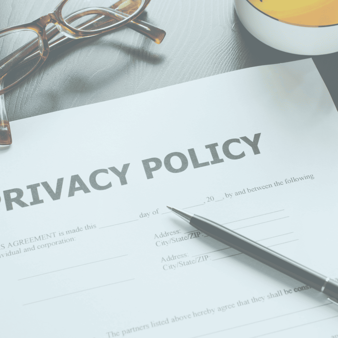a professionally branded privacy policy displayed on a table with glasses and a pen.