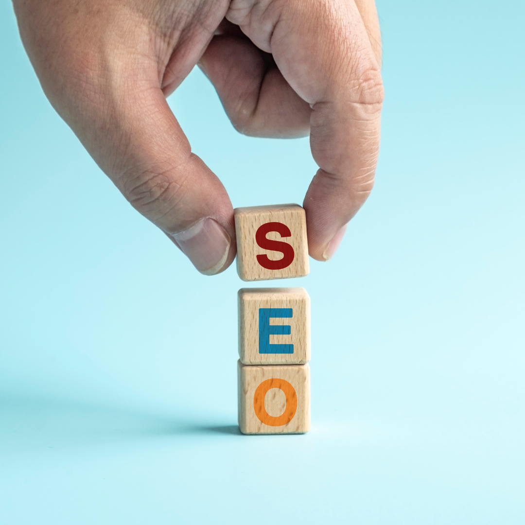 a hand holding wooden blocks with the word seo, representing a powerful tool for business success.